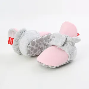 Detailed view of pink and grey baby sock shoes featuring soft knit and anti-slip soles