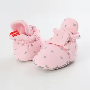 Pink cotton baby booties with gray star pattern and adjustable strap