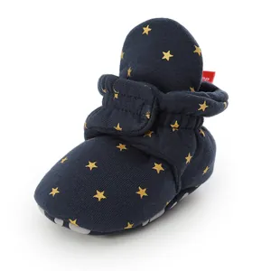 Close-up view of navy baby walker shoes with golden stars and soft non-slip soles
