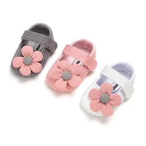 Set of three soft knit baby girl princess shoes with flower decor in grey, pink, and white