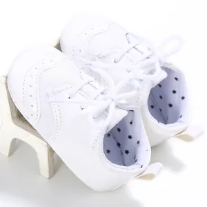 Detail of white baby walking shoes with soft sole, non-slip design and star lining.
