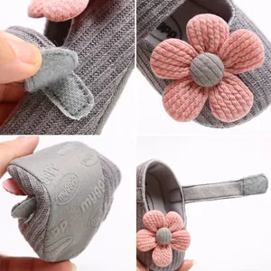Detailed view of knitted baby princess shoes with pink flower and soft anti-slip sole