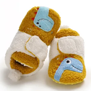 Detailed view of plush fleece baby pre-walker shoes featuring cute blue dinosaur patches