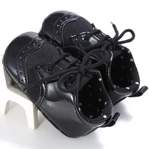 Detailed macro view of black patent baby oxford shoes featuring soft star patterned lining