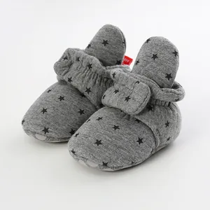 Detailed close-up of grey baby soft sole pre-walker shoes with black star patterns