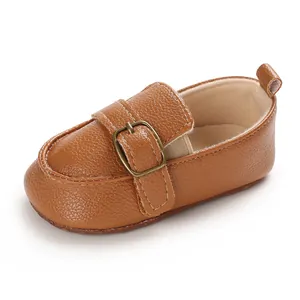 Vista dettagliata di scarpe primi passi per neonati in ecopelle marrone con fibbia