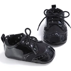 Detailed shot of black baby pre-walker shoes with patent leather and star lining