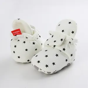 Close-up detail of soft sole cotton baby walker shoes with black star pattern print