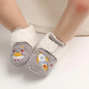 Close-up of soft fleece baby walker shoes with cartoon rocket embroidery