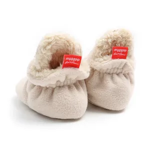 Close-up of soft-sole fleece-lined baby winter boots with fuzzy texture and red tag