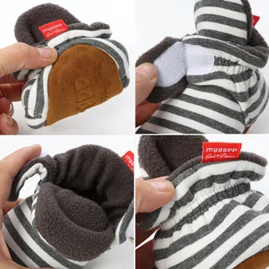 Detail views of baby soft sole socks shoes with warm fleece lining and velcro strap