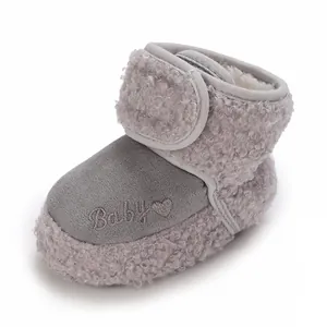 Close-up of warm grey fleece infant snow boots with heart and Baby embroidery detail