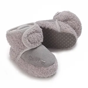 Detailed shot of grey fleece baby snow boots with embroidered Baby heart pattern logo