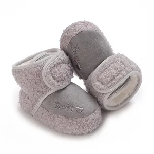 Close-up view of warm grey fleece baby snow boots with embroidered Baby logo and heart