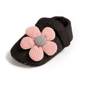 Macro view of soft-sole knit baby girl princess shoe featuring a 3D pink flower