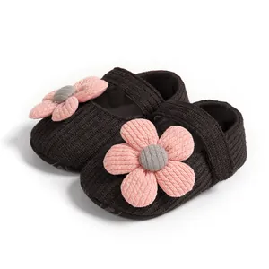 Macro view of hand-knitted flower detail on soft-soled baby princess shoes