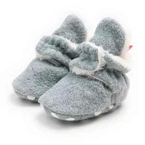 Detail of warm grey plush baby winter boots with soft sole and velcro closure