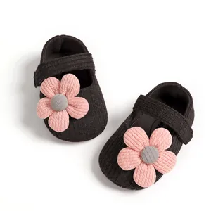 Detail view of pink knit flower decorations on soft-sole baby girl princess shoes