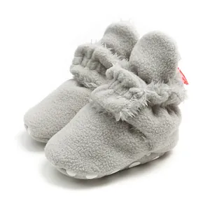 Cozy grey plush baby booties with soft sole and fuzzy lining for winter warmth