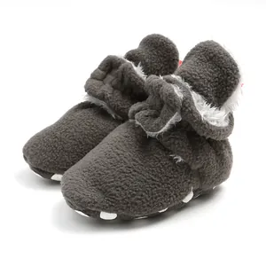 Close-up of warm dark grey fleece baby booties with soft white lining for winter