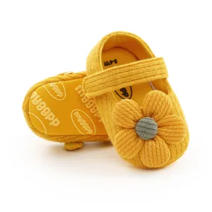 Close-up of yellow knit baby shoes with 3D flower and soft anti-slip soles