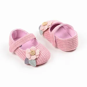 Detailed view of pink ribbed baby girl princess shoes with floral button decoration