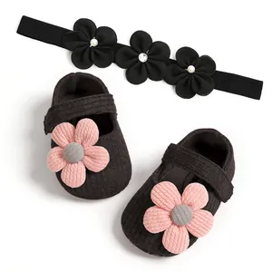 Macro detail view of soft-sole baby girl princess shoes with pink flowers and headband