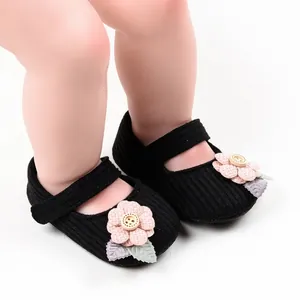 Black knit baby girl princess shoes with pink flower button detail and soft sole.
