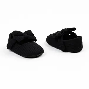 Detailed view of black ribbed infant baby girl Mary Jane pre-walker shoes with large bows