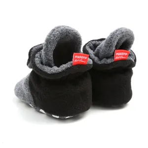 Detailed back view of warm winter fleece-lined baby booties with red soft brand tags