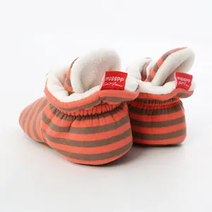 Back view detail of orange striped baby walker booties with warm white fleece lining