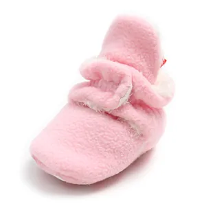 Macro view showing the soft texture and warm fleece lining of pink baby winter bootie