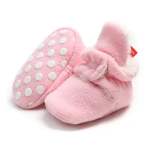 Soft pink fleece baby booties with warm lining and anti-slip dot soles for winter.