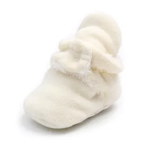 Close-up of soft white fleece fabric and plush lining on infant winter walking boots.