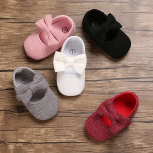 Overhead view showing various colors of knitted baby shoes with cute bow details