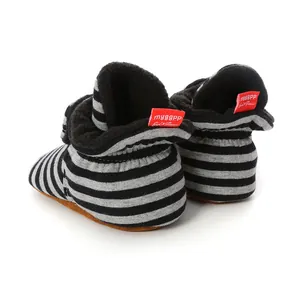 Detailed back view of striped baby booties showing the soft fleece lining and red brand label