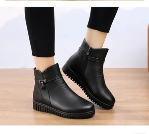 Nahaufnahme von flachen schwarzen Damen-Stiefeletten am Modell in einem Innenraum