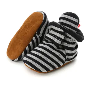 Detailed macro view of soft-sole striped baby walking shoes with warm fleece lining and strap