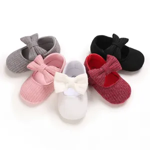 Detailed view showing five colors of knitted soft-sole baby walking shoes with bows.