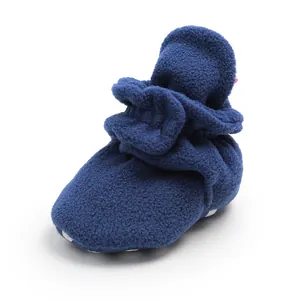 Close-up macro view of navy blue soft fleece baby bootie with warm textured fabric