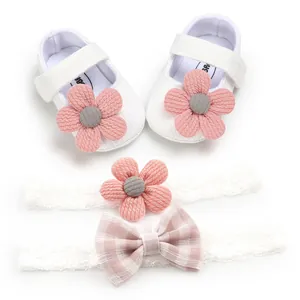 Detailed view of white infant girl flower shoes and matching lace headbands gift set