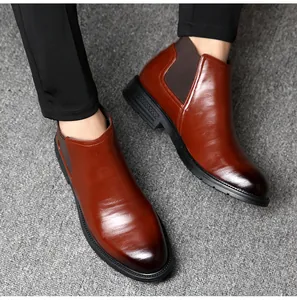 Close-up of premium brown leather men's Chelsea boots featuring a sleek polished finish
