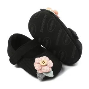 Detailed view of black baby knit walking shoes with pink flower and anti-slip magic sole