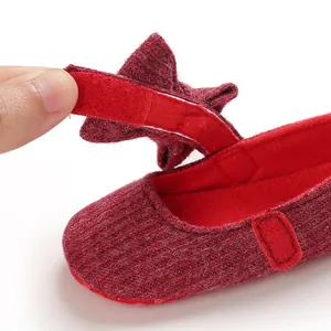 Close-up detail of the Velcro strap and soft knit texture on baby walking shoes.