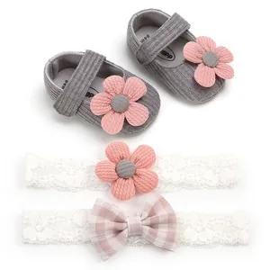 Detailed view of grey knit baby girl princess shoes with pink floral lace headband set