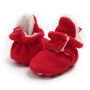 Close-up of red fleece winter baby boots with soft fuzzy lining and non-slip sole