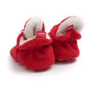Soft red fleece baby booties with warm white fuzzy lining detail
