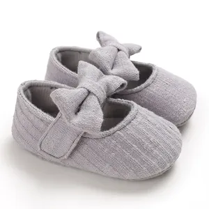 Grey infant walking shoes with soft soles and decorative bows for baby girls aged 0-1