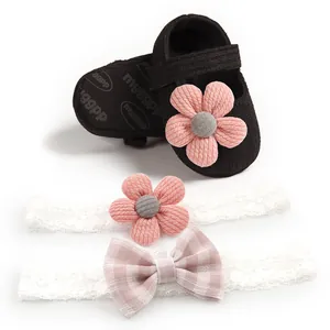 Delicate set of black knit baby princess shoes with pink flowers and lace headbands