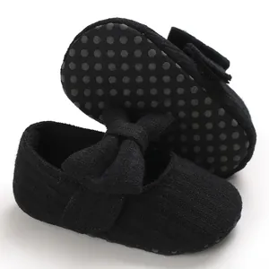 Close-up view of black knit baby walking shoes with anti-slip soft sole and bow